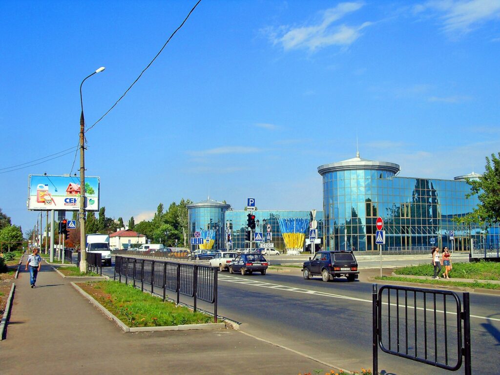 A city street with cars driving down it